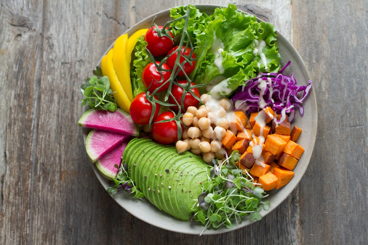 Mediterranean-style meal plan with olive oil, fresh herbs, and colorful vegetables